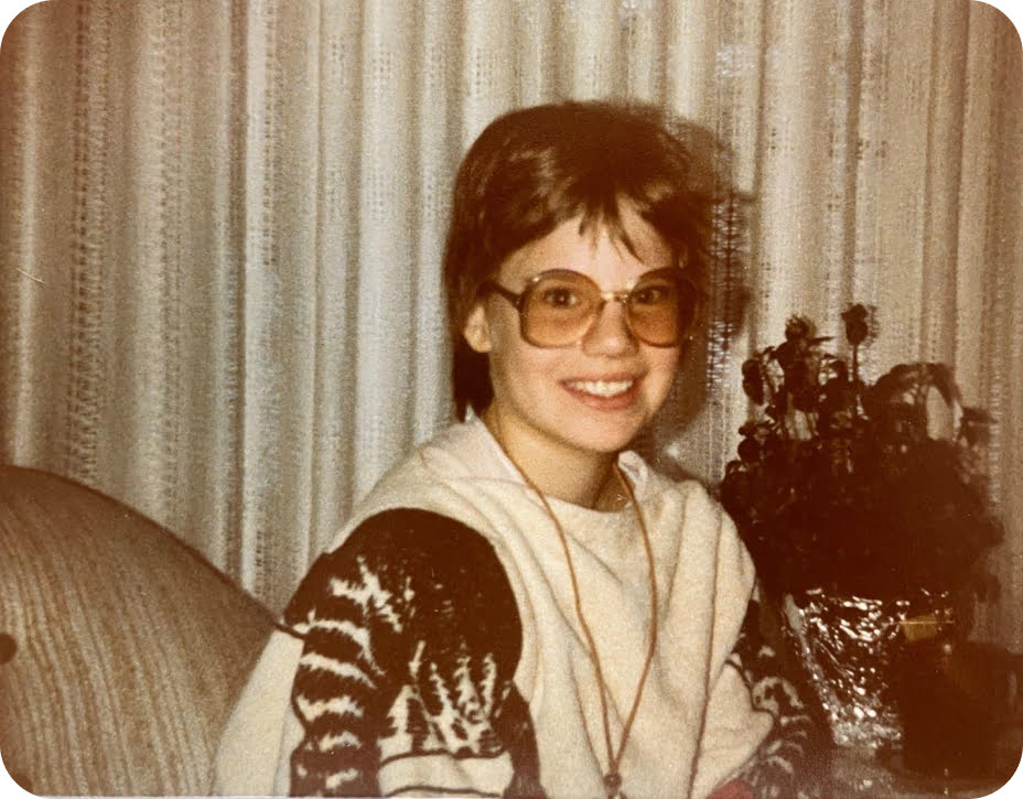 Michèle in 1979 – big glasses, bad haircut, dressed in a poncho made out of two bath towels