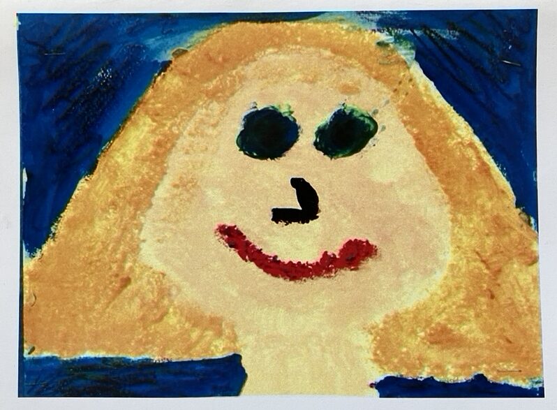 a smiling child's self-portrait
